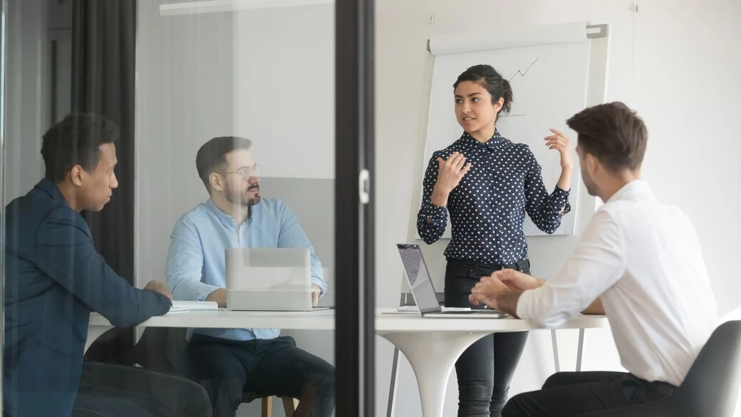 Business people listening to woman giving presentation Business people listening to woman giving presentation