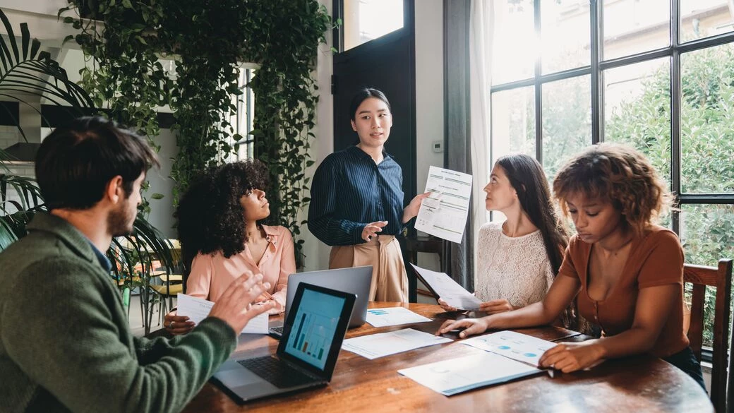 Multiracial group discussing business Multiracial group discussing business