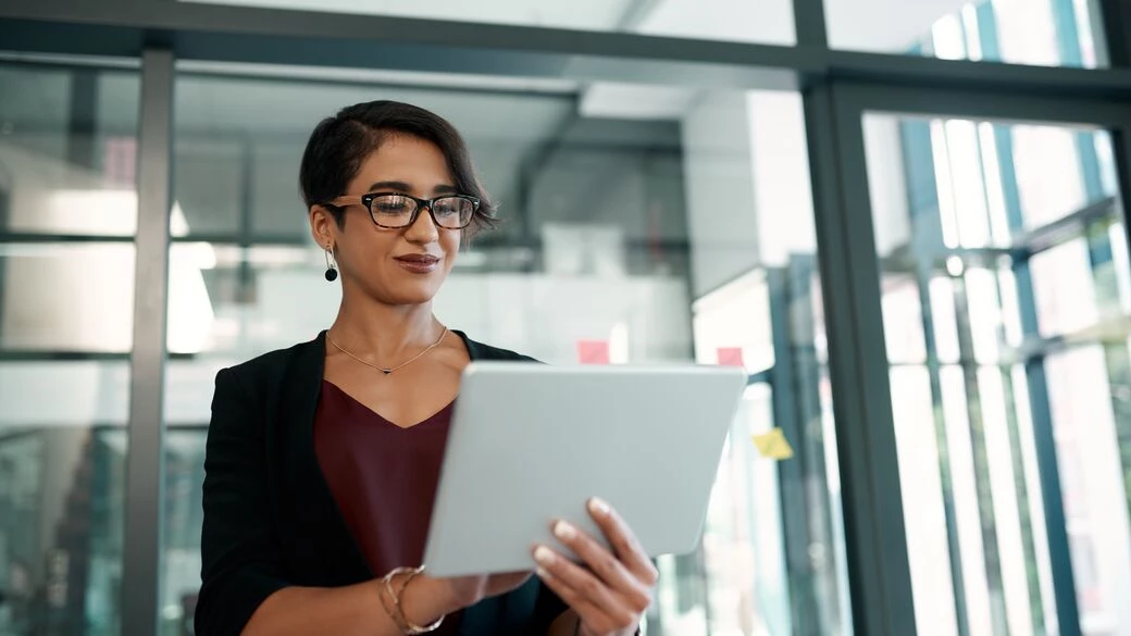 Woman looking a tablet at office Woman looking a tablet at office