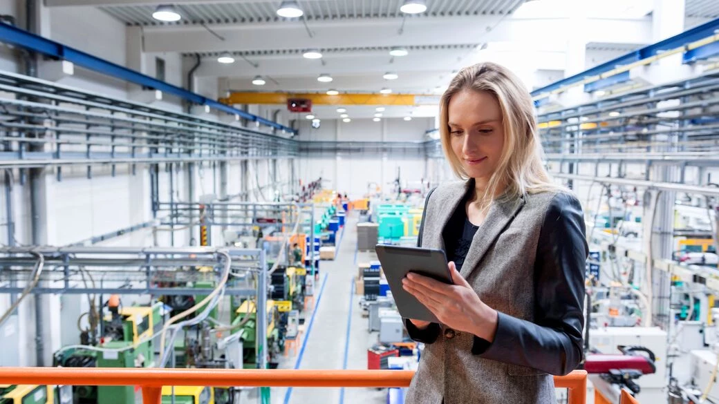 Female manager looking a tablet at factory